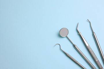 Dentist's instruments on a blue background close up top view 