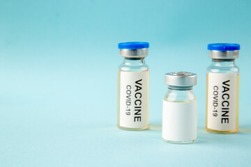 front view antivirus vaccines in little cans on blue background virus illness color health covid-