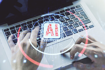 Double exposure of creative artificial Intelligence abbreviation with hand typing on computer...
