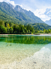 Beautiful turquoise lake with Alps mountains in the background. Beautiful sunny day in picturesque Slovenia - Kranjska Gora. 