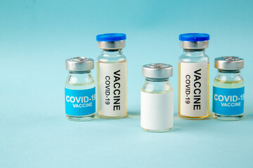 front view antivirus vaccines in little cans on blue background virus illness color health pandemic covid- isolation lab experiment