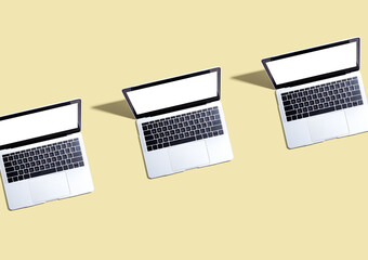 Fototapeta na wymiar Three laptop computers with shadow - Flat lay