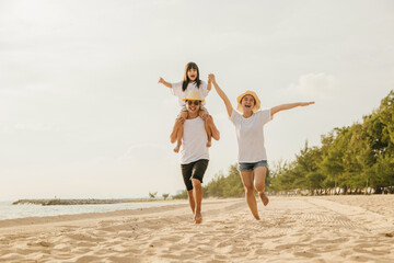 Road trips day. Happy family people having fun in summer vacation on beach, daughter riding on...