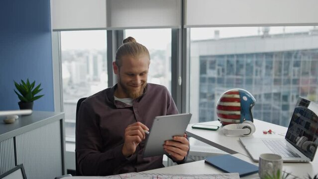 Positive man painting stylus digital tablet office closeup. Designer working pad