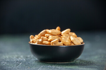 front view little salted crackers inside plate on a dark background crisp color snack cips salt pepper bread dry rusk food
