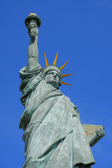 Fototapeta premium Detail of the Statue of Liberty on the Island of Swans in the center of the Seine river in Paris, France - Facing west, this copper sculpture is a gift from the American community in Paris