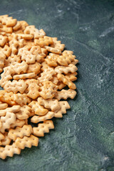 front view little salted crackers on dark gray background crisp color snack cips salt pepper bread dry rusk food