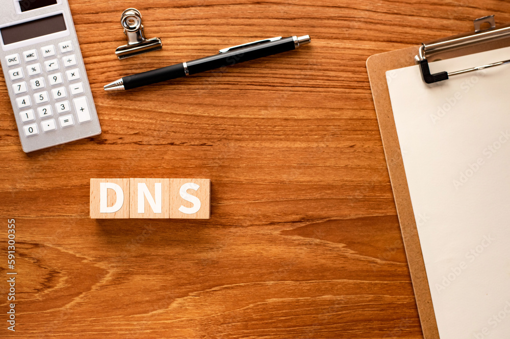 Poster there is wood cube with the word dns.it is an abbreviation for domain name system as eye-catching im
