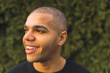 Close portrait of smiling young African American man with a buzz cut isolated. High quality photo