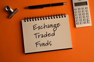 There is notebook with the word Exchange Traded Funds. It is an eye-catching image.