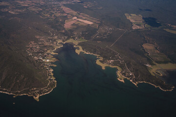 Cartography. View of the shoreline, field and ocean seen from the sky. 