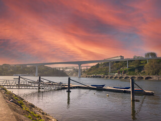 Fishing pier near the river beach of Areinho on the bank of Gaia on the Douro river at sunset. Portugal