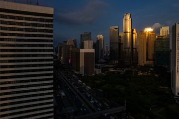 Naklejka na ściany i meble aerial photos of Sudirman street and Jakarta Skyline in the golden hour. 