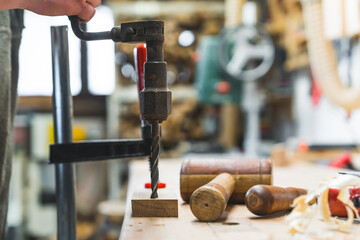 Carpenter studio interior. Brace - manual drill, mallet and other traditional woodworking tools in use. Blurred background. High quality photo