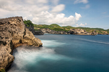 Long exposure photograph sea water hitting the volcanic rock on Bali Island