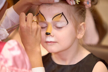 drawing on the face of a little girl make-up