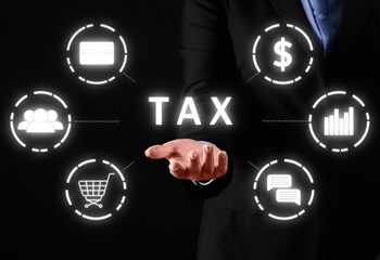 Businesswoman using virtual screen with word TAX on dark background