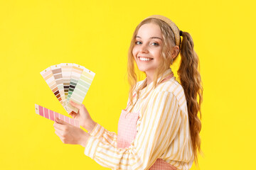 Female artist with paint color palettes on yellow background