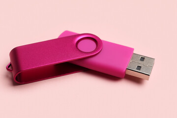 USB flash drive on pink background