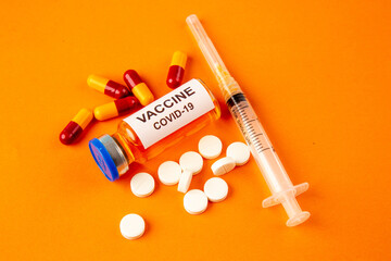 top view antivirus vaccine with injection and pills on orange background lab disease covid- health pandemic virus science illness