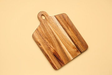 Wooden cutting board on yellow background