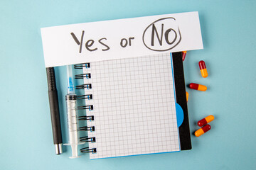 top view antivirus vaccine with pills injection and note on blue background lab disease virus health pandemic covid- isolation