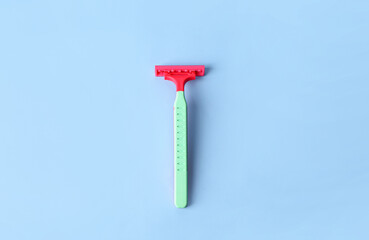 Colorful safety razor on color background