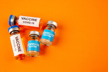 top view antivirus vaccines in little cans on orange background lab disease covid- health pandemic science virus color