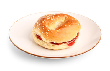 Plate of tasty bagel with strawberry jam on white background