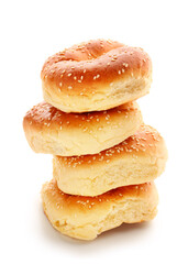 Tasty bagels with sesame seeds on white background