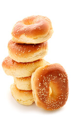 Tasty bagels with sesame seeds on white background