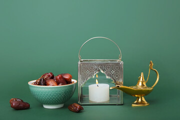 Muslim lantern with Aladdin lamp and dates on green background