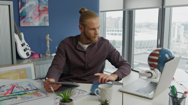 Serious man working laptop city apartment closeup. Retoucher touching display