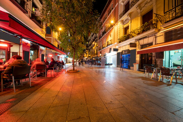 Shopping streets with restaurants at Madrid city center illuminated at night