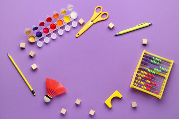 Frame made of toys and school stationery on purple background. Children's Day celebration