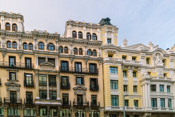 Fototapeta na wymiar Historic old buildings in the shopping street Gran Via in Madrid before sunset