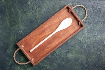 top view brown wooden desk with plastic utencil inside on dark background color wood cutting board photo box cuisine