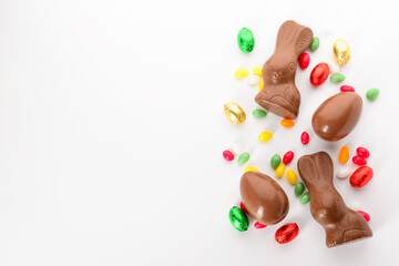 Chocolate Easter eggs, bunnies and candies isolated on white background