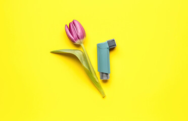 Asthma inhaler with tulip on yellow background