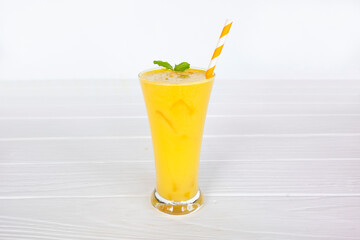 Mango smoothies yellow colorful fruit juice milkshake blend beverage healthy high protein the taste yummy In glass,drink to lose weight drink episode morning on white gray background.