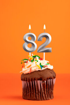 Candle number 82 - Cake birthday in orange background