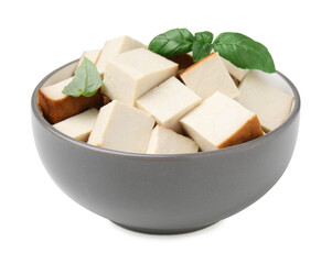 Bowl of delicious smoked tofu cubes with basil isolated on white