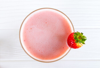 Strawberry yogurt fruit juice smoothie pink colorful fruit juice milkshake blend beverage healthy high protein the taste yummy In glass drink episode morning on white wood background.