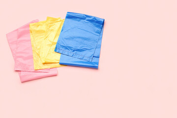 Different garbage bags on pink background