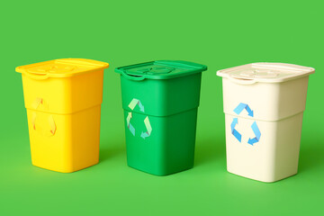 Containers for garbage on green background. Recycling concept
