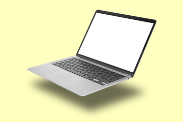 Modern laptop flying on pale light yellow background