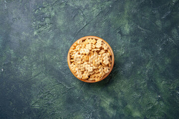 top view little crackers inside plate on a dark background crisp color snack salt bread rusk food...