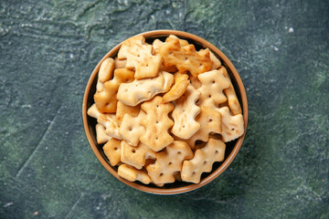 top view little salt crackers inside plate on dark background crisp salt pepper color snack cips bread