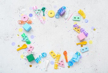 Frame made of baby toys with confetti on white background. Children's Day celebration