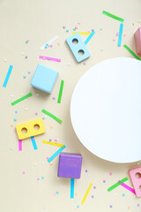 Fototapeta na wymiar Blank card with baby blocks and confetti on beige background. Children's Day celebration